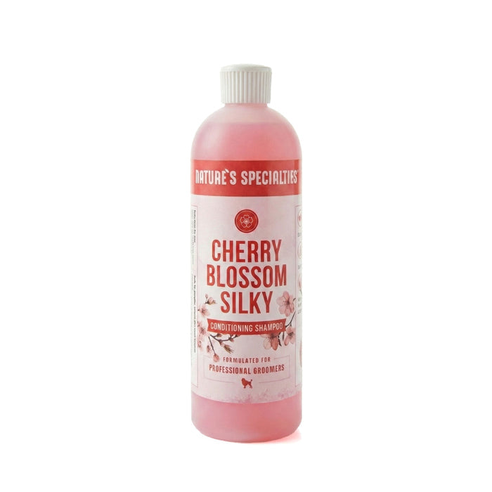 Bottle of Cherry Blossom Silky shampoo with a white label on a white background