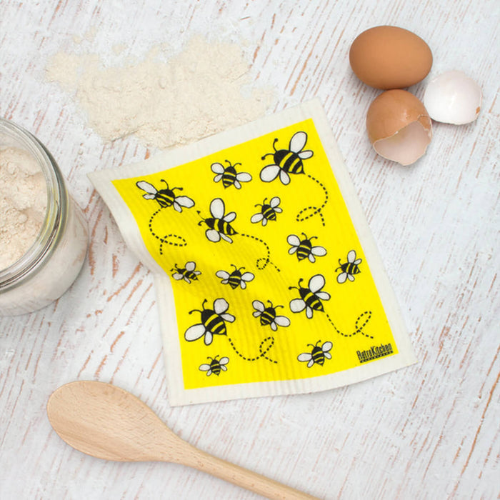 Compostable sponge cloth with a bee design on a bench.