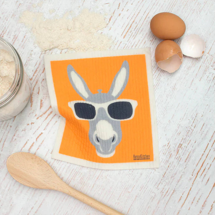 Compostable sponge cloth with a donkey design on a bench.