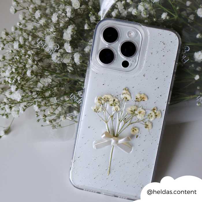 Clear phone case with pressed dried flowers, white bow detail, and babys breath accents.