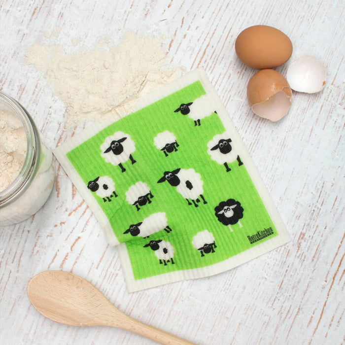 Compostable sponge cloth with a sheep design on a bench.