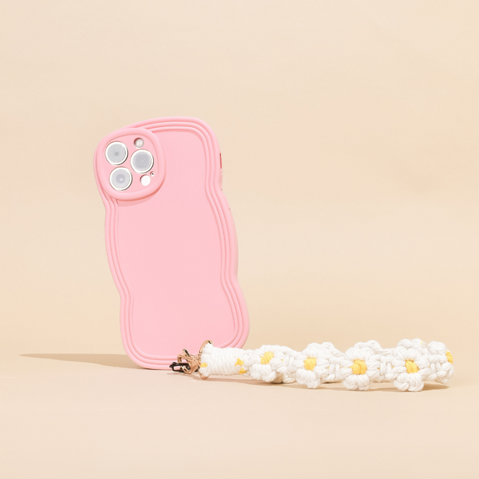 White daisy crochet phone strap bundle on a pink wavy phone case with keychain, set against a beige background.