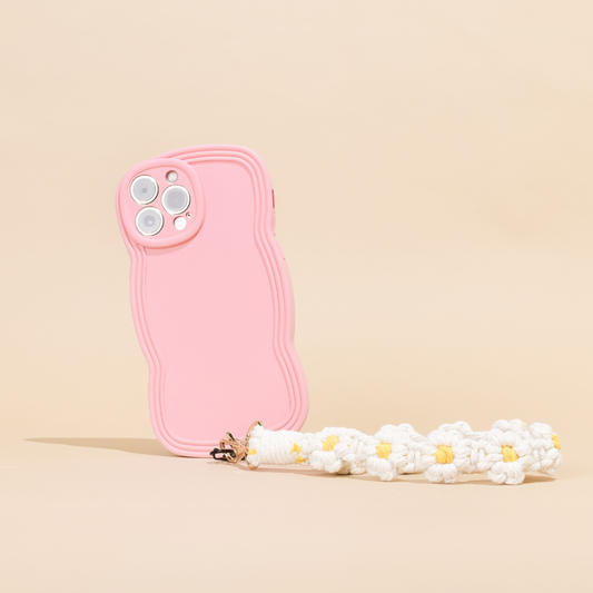 White daisy crochet phone strap bundle on a pink wavy phone case with keychain, set against a beige background.