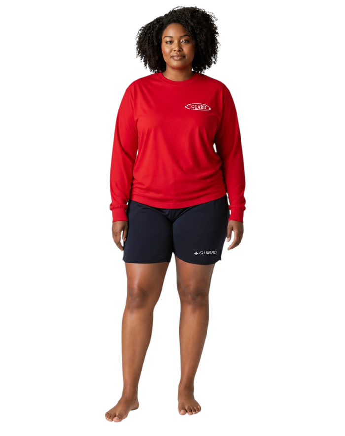 The Lifeguard Store red long sleeve Dri-Fit guard shirt worn by a woman with dark curly hair on a white background