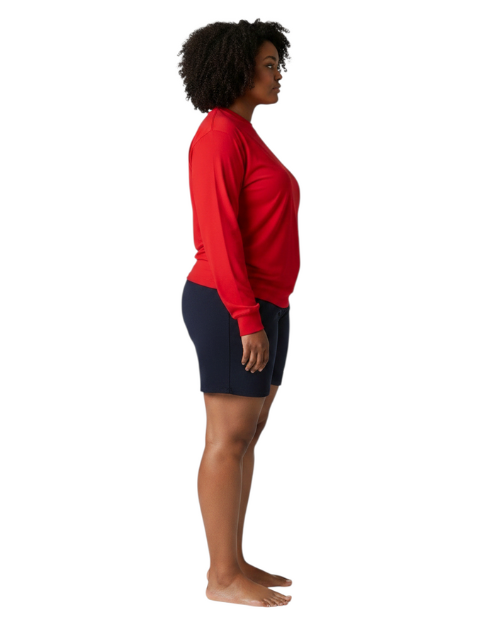 The Lifeguard Store red long sleeve Dri-Fit shirt worn by a model in profile view with navy shorts.