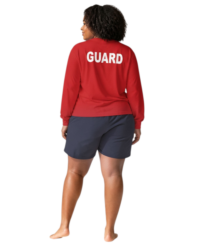 The Lifeguard Store red long sleeve Dri-Fit shirt with white GUARD text on the back worn by a female lifeguard.