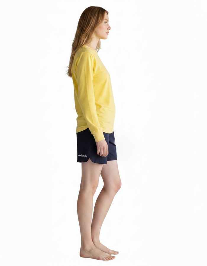 The Lifeguard Store yellow long sleeve Dri-Fit guard shirt worn by a model in profile view