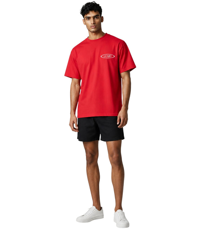 The Lifeguard Store red Dri-Fit short sleeve lifeguard t-shirt with white GUARD logo on chest worn by a male model