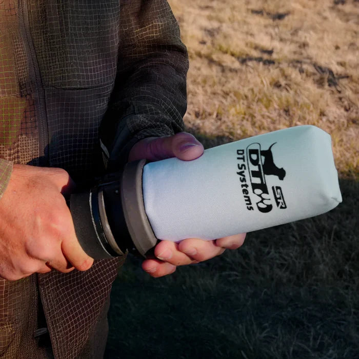 Person holding a white launcher dummy, black text and logo outdoors