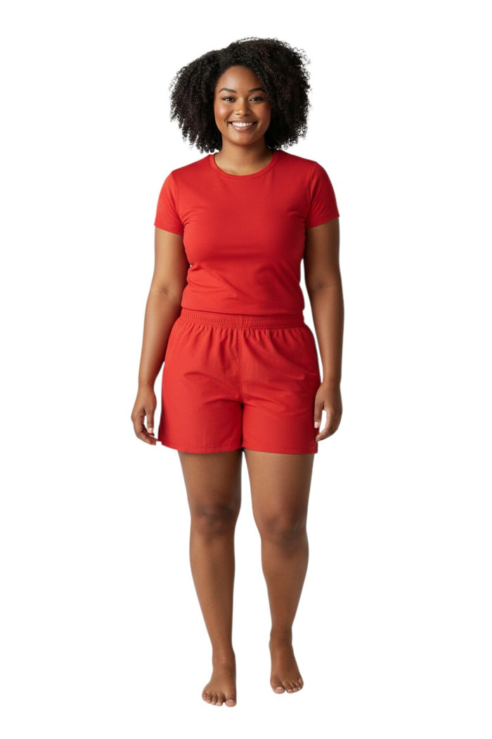 The Lifeguard Store Kiefer 4-Way Unisex Deck Short in solid red. Features elastic waist, drawstring, side pockets, and back velcro pocket.