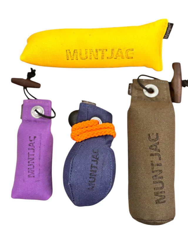 Collection of Muntjac products including a yellow dummy, purple dummy, blue dummy, and khaki dummy on a white background.