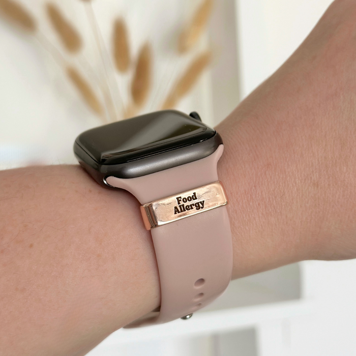Rose gold Coconut Lane medical watch charm with “Food Allergy” text on a pink smartwatch band.