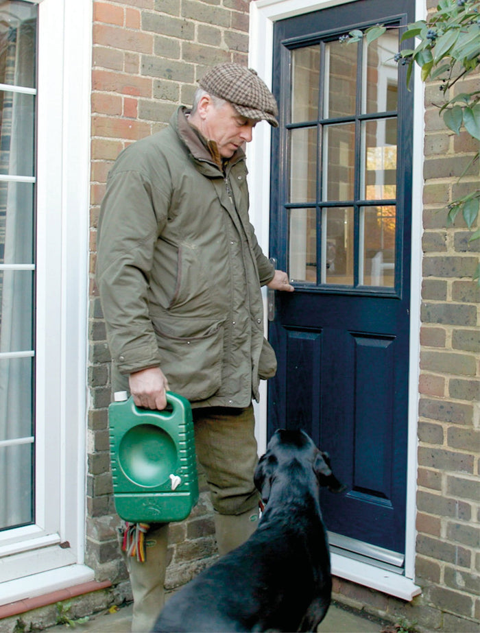 A dog owner carrying a portable dog water bowl sold by Muntjac Trading