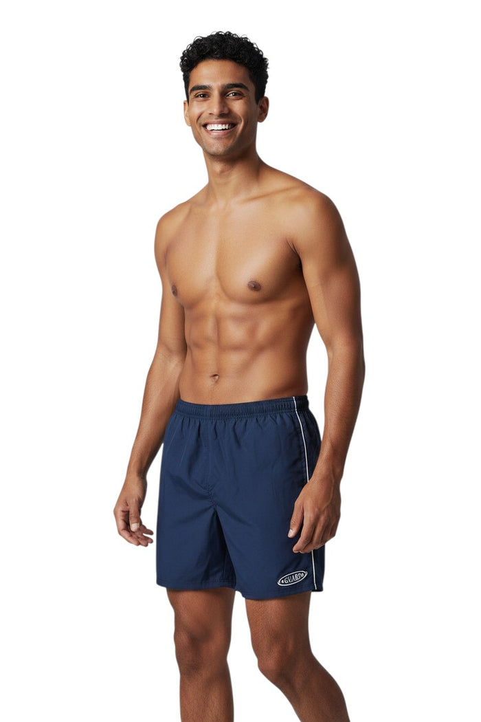 The Lifeguard Store navy blue nylon lifeguard trunks with white side stripe and GUARD logo on left leg. Elastic waistband.