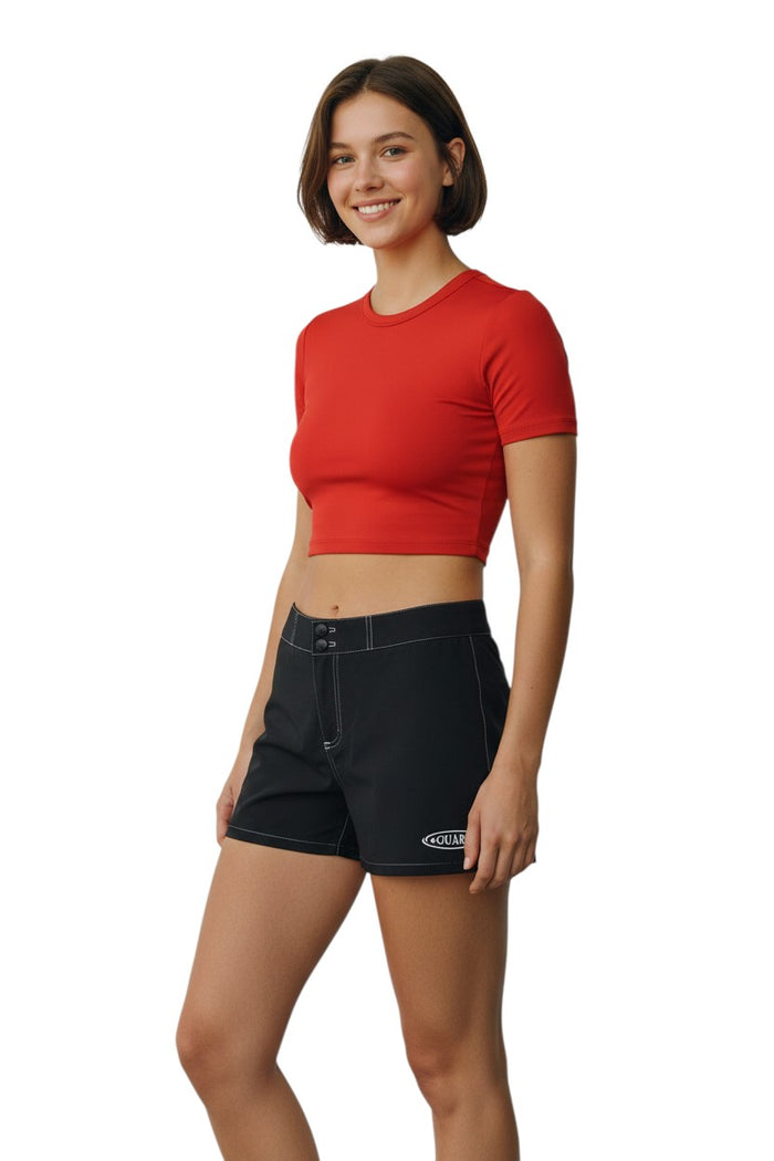 The Lifeguard Store black polyester-spandex Guard Flex shorts with drawstring waist and side pocket. Guard logo on left leg.