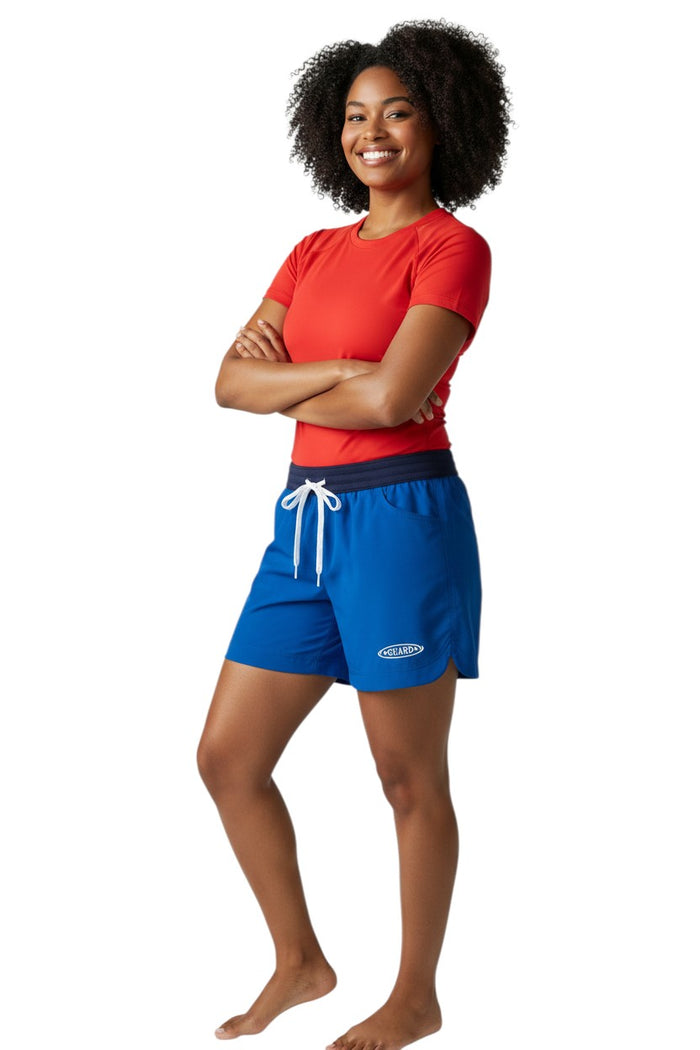 The Lifeguard Store RISE Guard Female Roll Short in royal blue polyester with elastic waistband, drawstring, and two front pockets. Features UPF30+ protection.