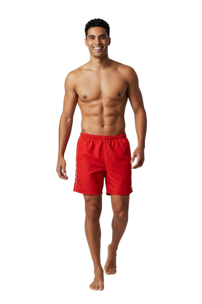 The Lifeguard Store RISE Guard Flex Short: Red polyester-spandex boardshorts with white piping and GUARD logo. Elastic waistband, drawstring, side pocket.