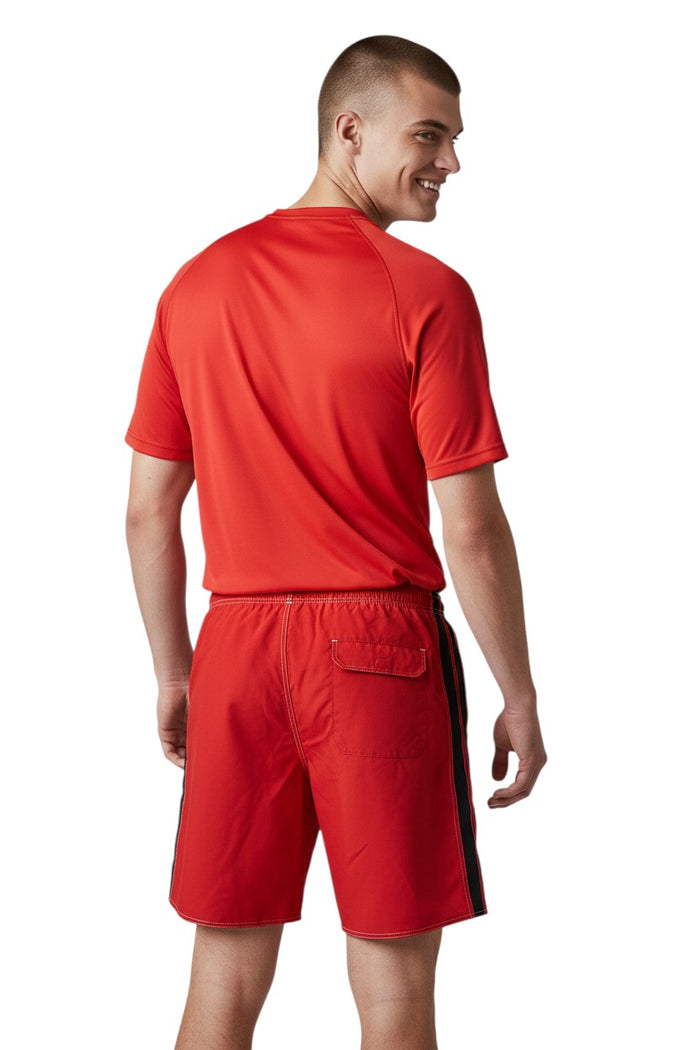 The Lifeguard Store red polyester board shorts with black and white side stripe, drawstring waist, and GUARD logo.