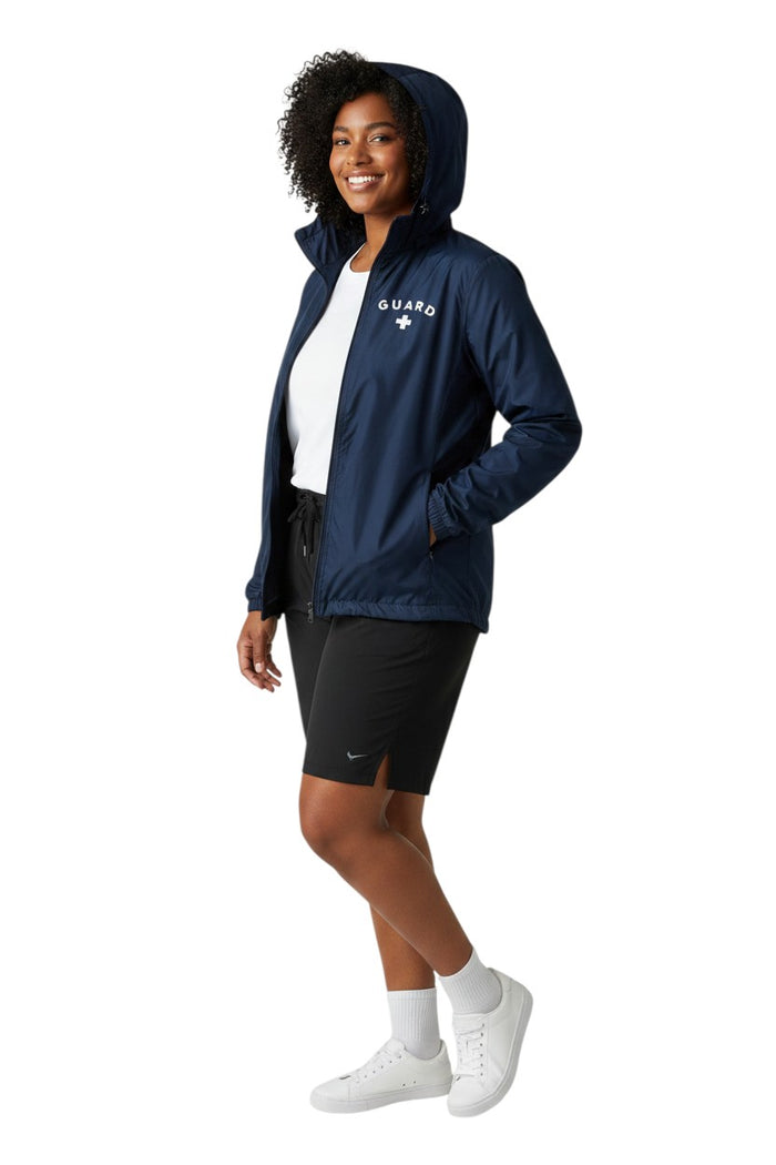 The Lifeguard Store navy blue waterproof jacket with "GUARD" and a white cross graphic on the chest.