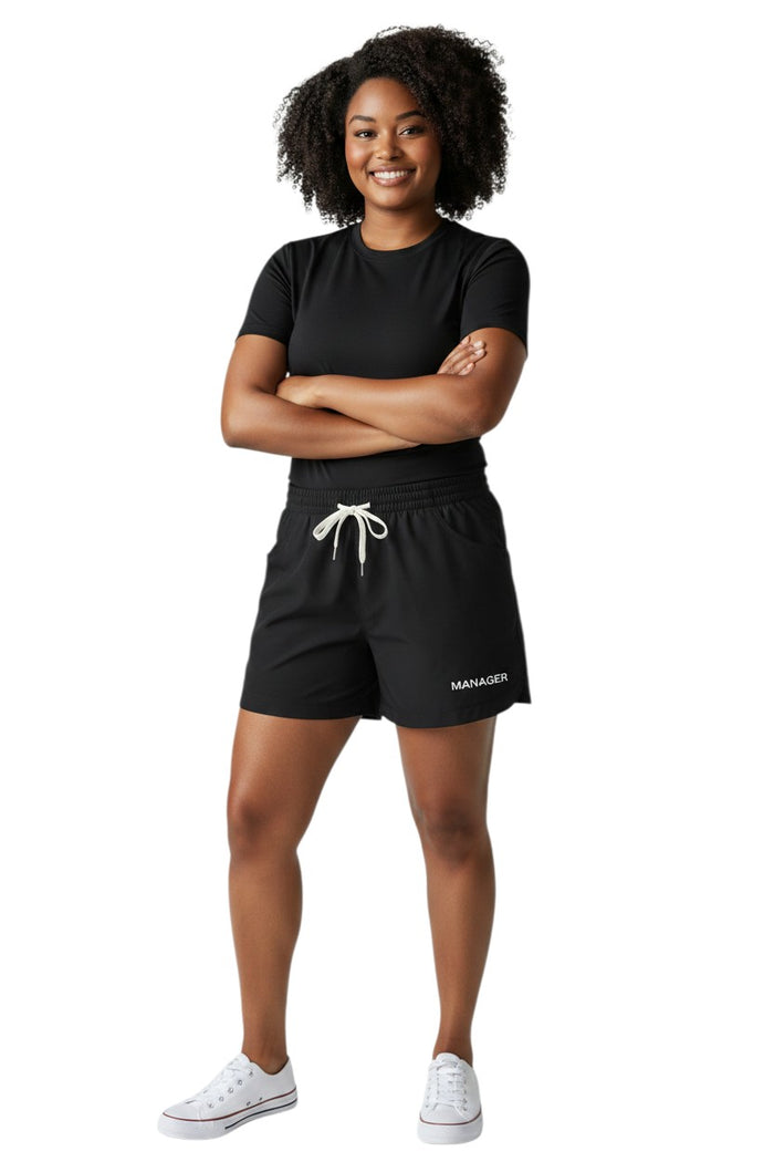 The Lifeguard Store black polyester roll shorts with elastic waistband, drawstring, and "MANAGER" text.