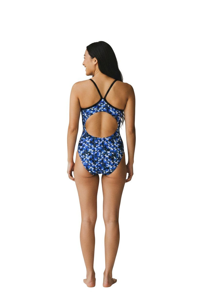 The Lifeguard Store RISE Sandies female swimsuit in blue, black, and white geometric print. Features H-back straps and large cutout.