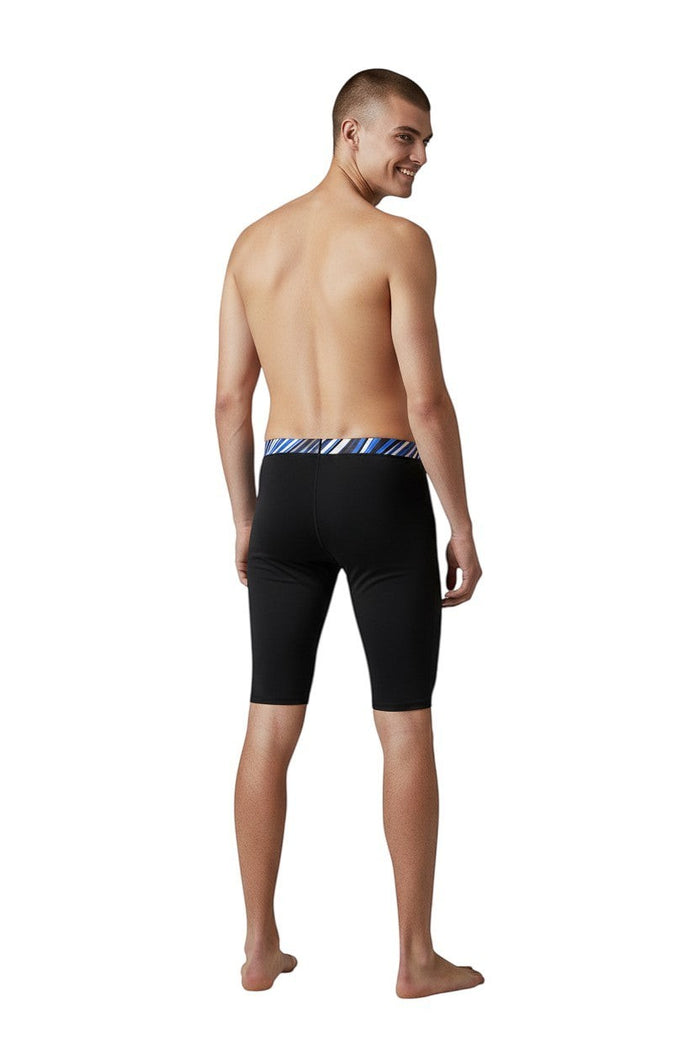 The Lifeguard Store RISE Sandies black poly jammer swimsuit with a blue, white, and black striped waistband.