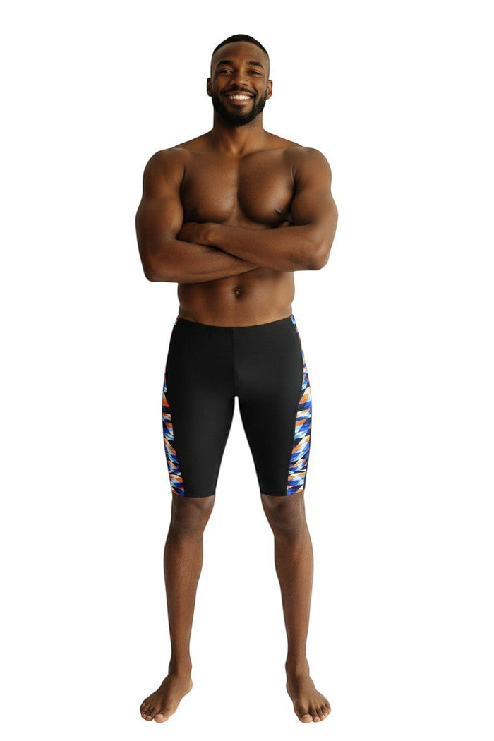 The Lifeguard Store RISE Sandies Swerve Poly Jammer swimsuit in black with a colorful geometric side panel. Polyester/Spandex blend.