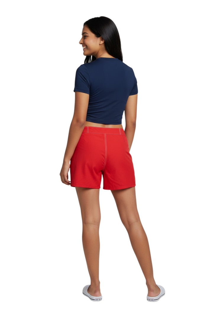The Lifeguard Store RISE Solid Female Flex Short in red polyester-spandex with white contrast stitching and a 5" inseam.