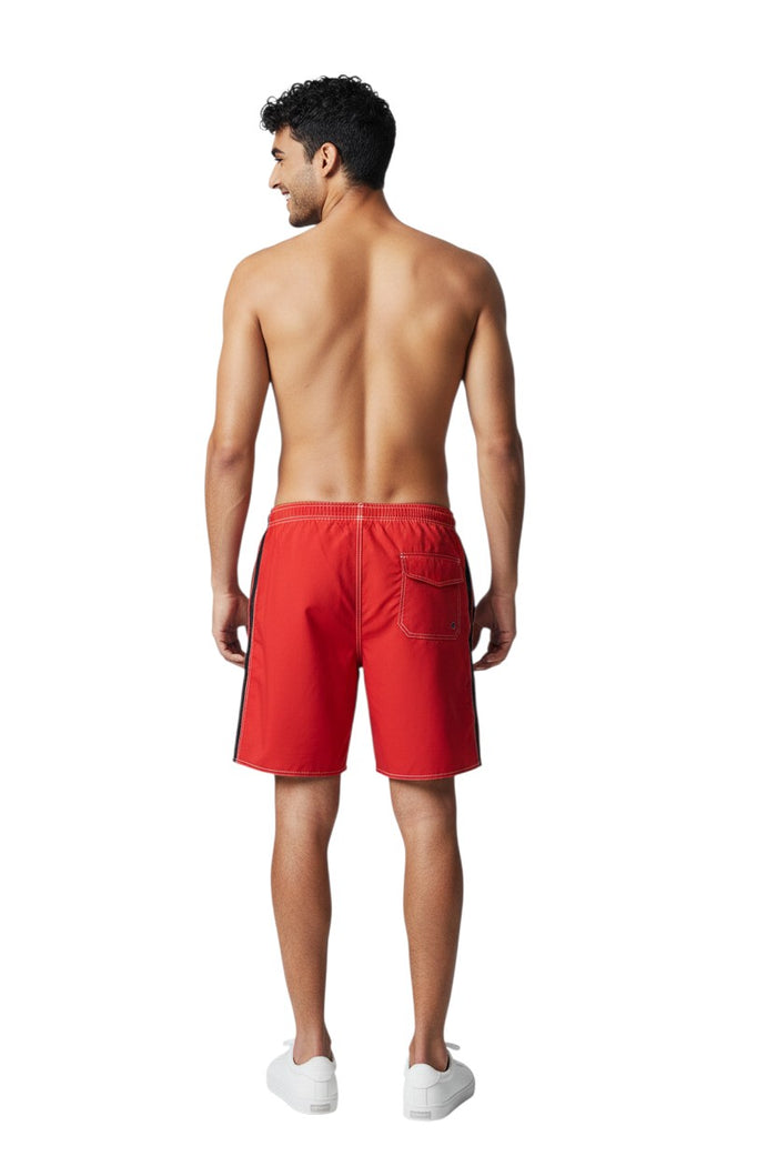 The Lifeguard Store red polyester board shorts with black side stripe, drawstring waist, and white contrast stitching.