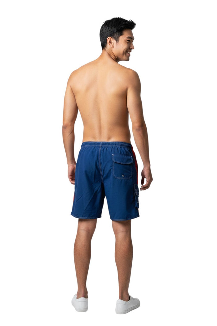 The Lifeguard Store RISE Solid Splice Board Short in blue with red side stripes and white contrast stitching. Features elastic waistband, drawstring, and cargo pocket.