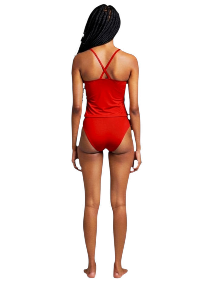 Back view of a model wearing The Lifeguard Store red RISE solid workout tankini with crisscross straps