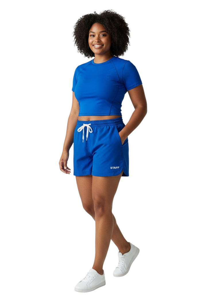 The Lifeguard Store royal blue polyester roll shorts with elastic waistband, drawstring, and "STAFF" logo.