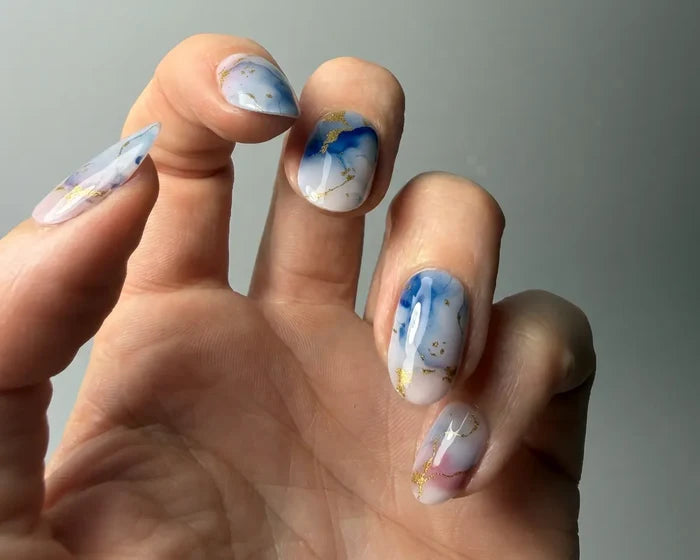Azure Tide semi-cured gel nail wraps worn on a hand