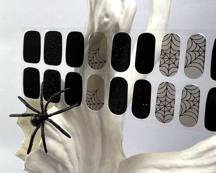 Black Widow gel nail wraps displayed on a nail tree, Halloween styling