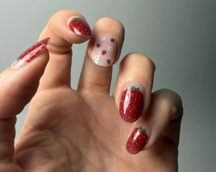 Strawberry Fields semi-cured gel nail wraps worn on a hand