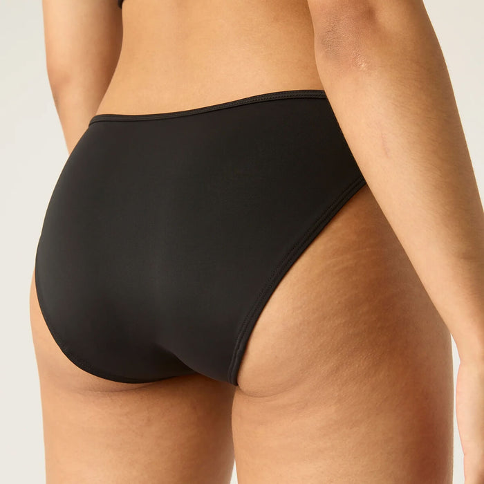 Closeup back view of model wearing Modibodi Swimwear Bikini Brief in black with light to moderate absorbency, period swimwear made with sustainable materials.