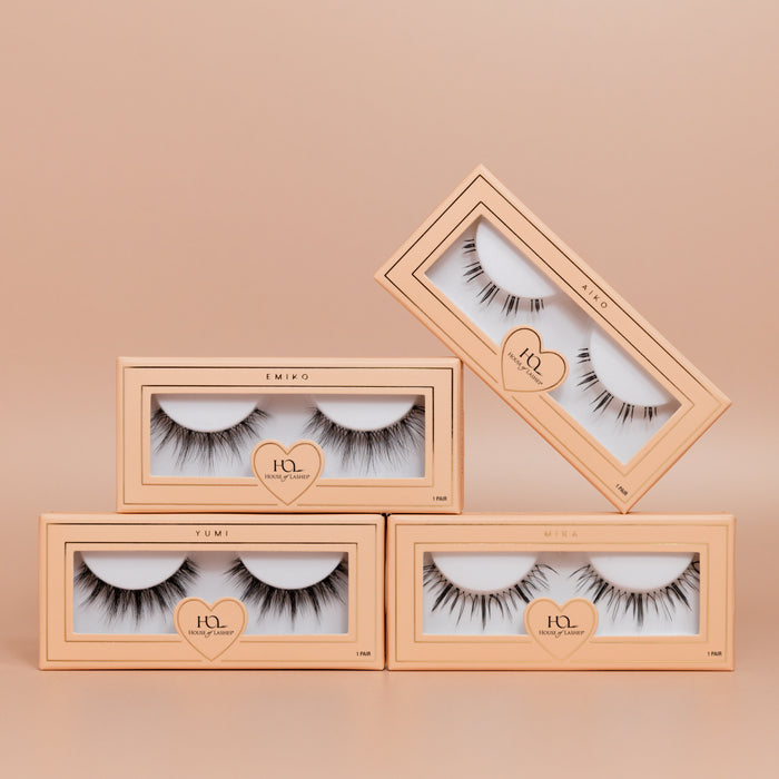 The Darling Set eyelash boxes in pale peach packaging stacked with clear windows showing long lashes