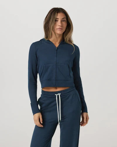 Woman wearing a Vuori - Halo Mini Full Zip Hoodie on a white background