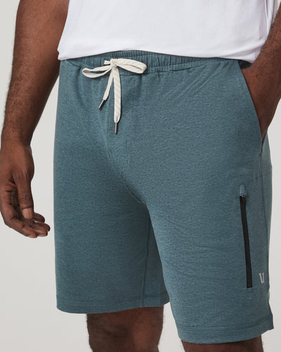Vuori - Sunday Performance Short 8" with a drawstring and zipper pocket on a plain background