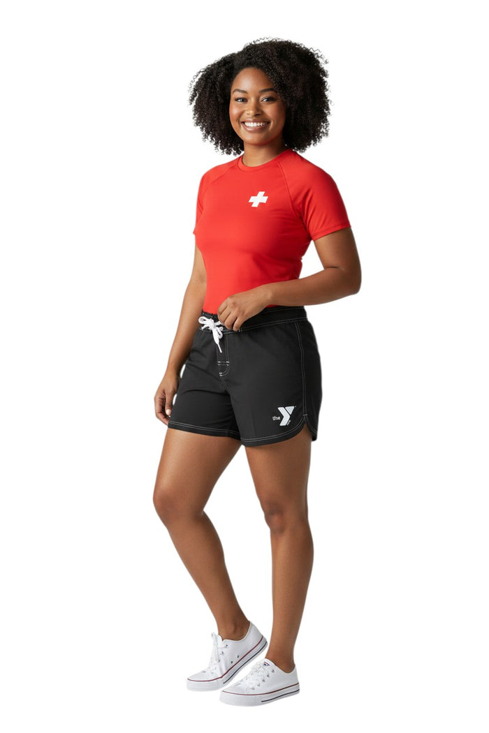 The Lifeguard Store black polyester swim shorts with 5" inseam, drawstring waist, side pocket, and YMCA logo.