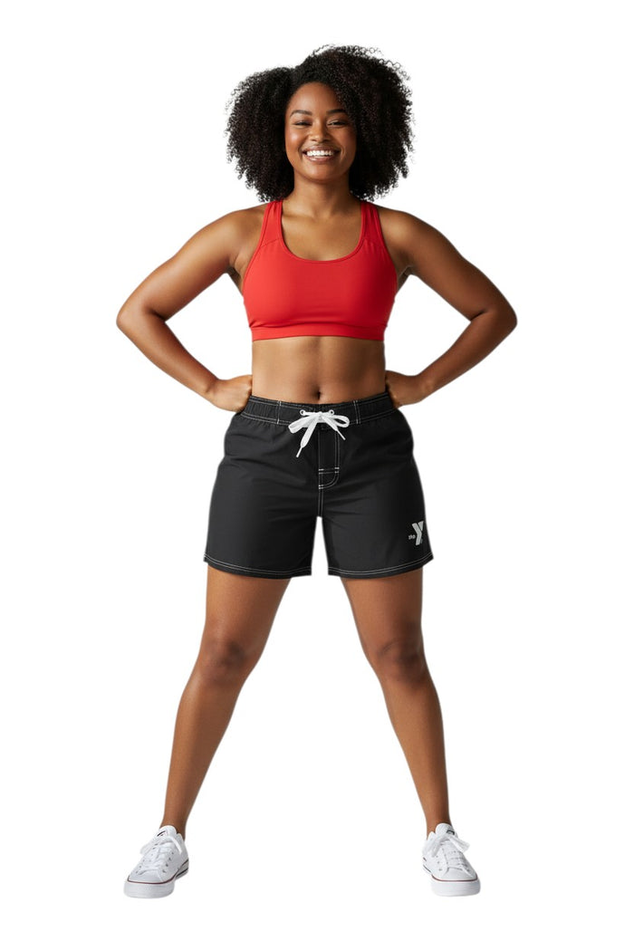 The Lifeguard Store black polyester swim shorts with 5" inseam, drawstring waist, side pocket, and YMCA logo.