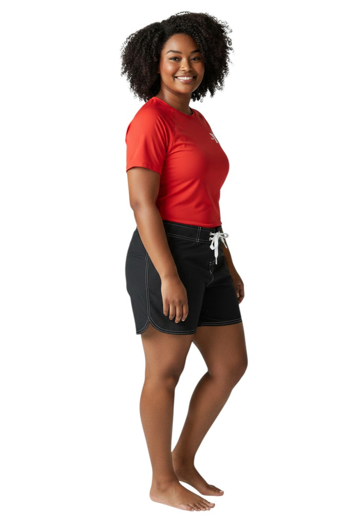 The Lifeguard Store black polyester swim shorts with 5" inseam, drawstring waist, side pocket, and YMCA logo.