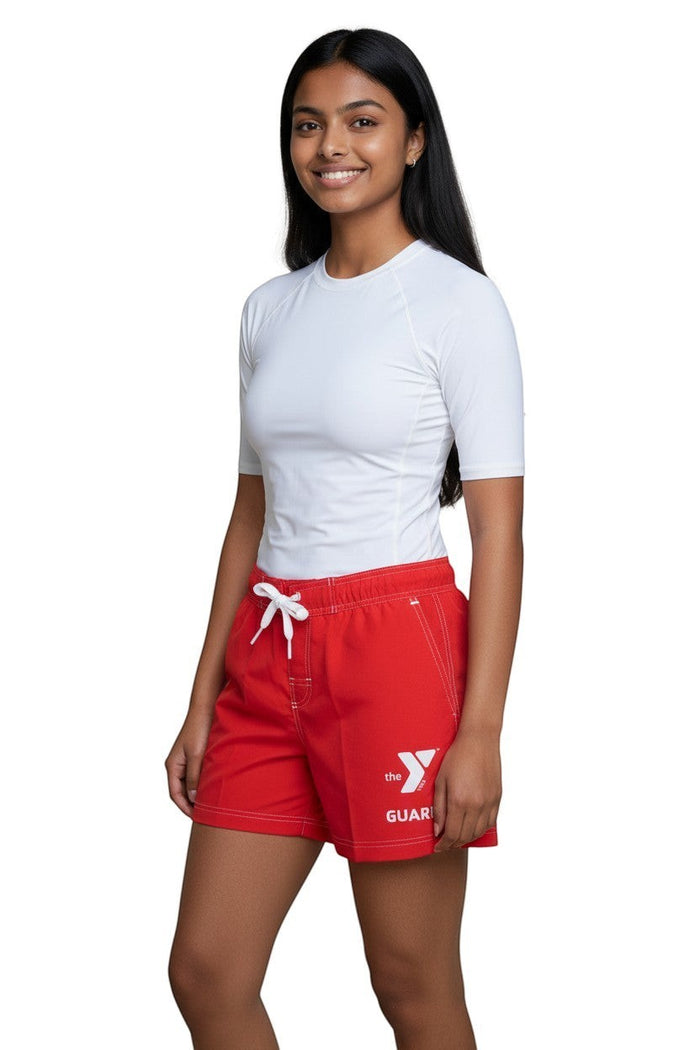 The Lifeguard Store red polyester swim shorts with 5" inseam, elastic waistband, drawstring, and YMCA Guard logo.