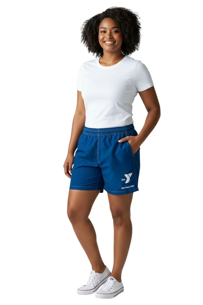 The Lifeguard Store blue polyester-spandex board shorts with elastic waistband, drawstring, and YMCA Instructor logo. Features a side pocket.