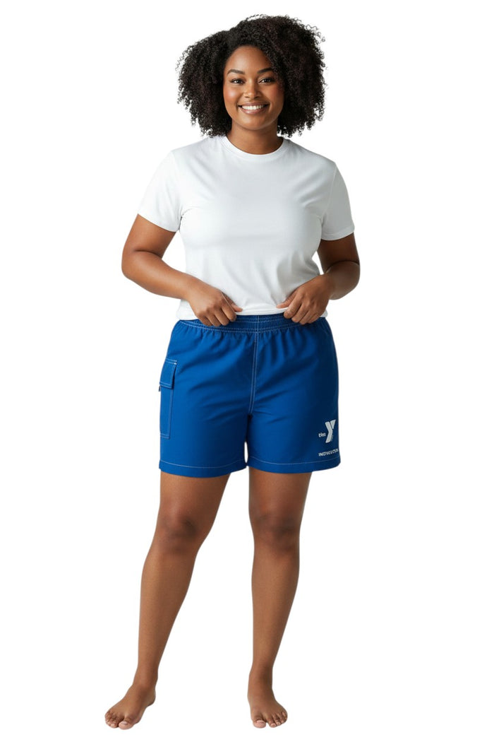 The Lifeguard Store blue polyester-spandex board shorts with elastic waistband, drawstring, and YMCA Instructor logo. Features a side pocket.