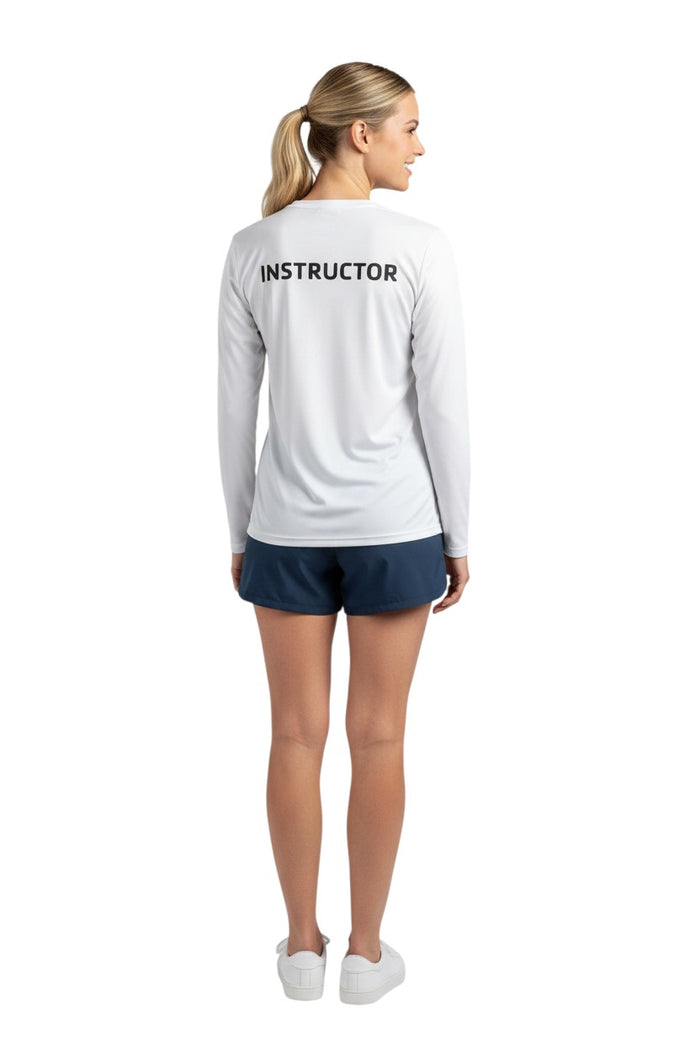 The Lifeguard Store white long sleeve rashguard with black "INSTRUCTOR" text on back. UPF50+ protection.
