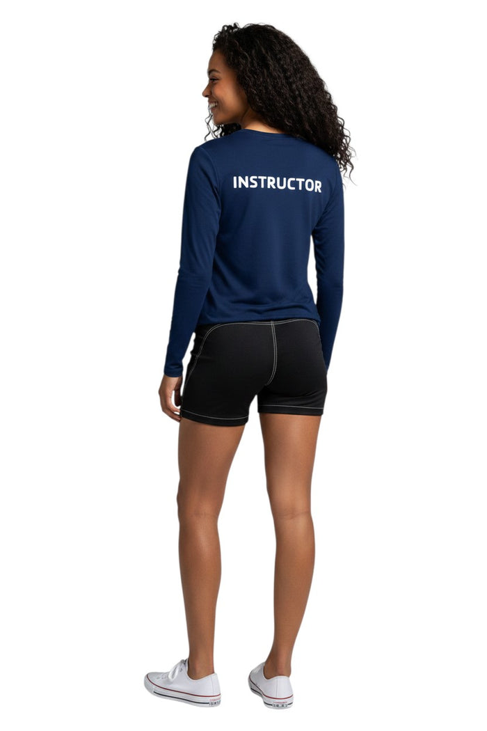 The Lifeguard Store navy blue long sleeve rashguard with white "INSTRUCTOR" text on back. Polyester/spandex blend with UPF50+ protection.