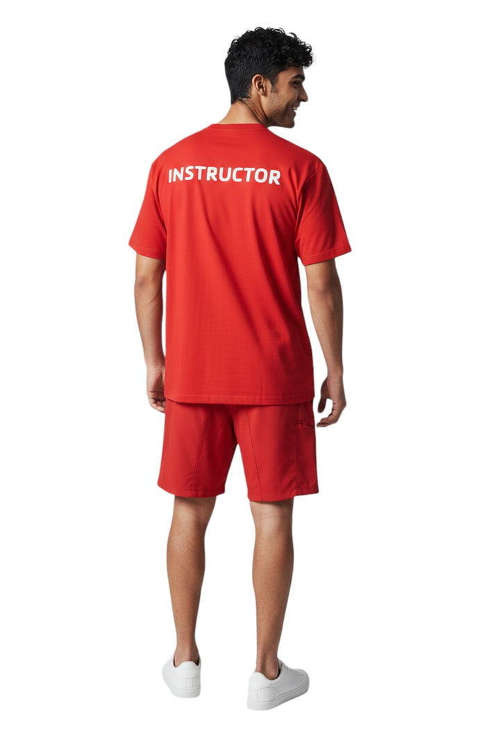 The Lifeguard Store red short sleeve rashguard with white "INSTRUCTOR" text on back. Made of polyester and spandex.