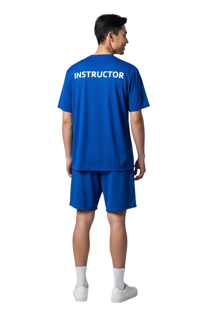 The Lifeguard Store blue short sleeve rashguard with "INSTRUCTOR" printed in white on the back. Made of polyester and spandex.